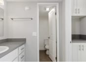 Thumbnail 15 of 17 - a bathroom with a sink and a toilet and a mirror