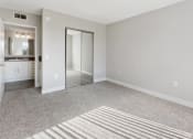 Thumbnail 6 of 17 - an empty living room with a mirror and a closet