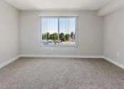 Thumbnail 5 of 17 - an empty living room with a large window and carpet