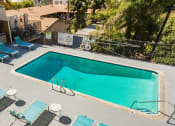 Thumbnail 2 of 17 - a pool is shown at a hotel with blue chairs