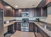 Thumbnail 9 of 32 - Courtside Apartments clubhouse kitchen