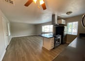 Thumbnail 2 of 18 - A kitchen with a stove top oven and a microwave.