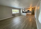 Thumbnail 1 of 18 - A room with wooden flooring and a window.