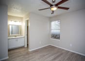 Thumbnail 14 of 20 - Bedford Oaks Apartments bedroom with sink and mirror