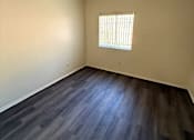 Thumbnail 6 of 22 - Sorrento Villas bedroom with a window and wooden flooring.