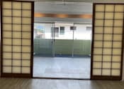 Thumbnail 4 of 13 - A room with a ceiling fan and sliding glass doors.