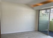 Thumbnail 6 of 13 - A room with a glass door and a tiled floor.