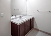 Thumbnail 18 of 25 - A bathroom with a sink and a mirror.