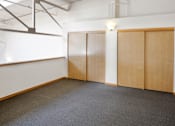 Thumbnail 23 of 25 - Three brown doors in a white room.