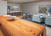 Thumbnail 8 of 25 - A wooden table with a fish bowl on it in the middle of a room.