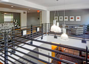 Thumbnail 11 of 25 - A staircase with a metal railing and a glass balustrade.