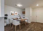 Thumbnail 20 of 21 - A dining room with a wooden table and chairs.