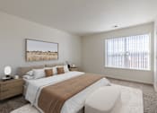 Thumbnail 18 of 21 - A bedroom with a large bed and a painting on the wall.