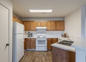 Thumbnail 16 of 21 - A kitchen with wooden cabinets and a white fridge.