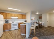 Thumbnail 15 of 21 - A kitchen with wooden cabinets and a white fridge.