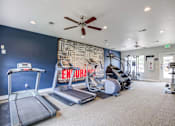 Thumbnail 17 of 20 - A gym with treadmills, elliptical machines, and a wall with a word cloud.