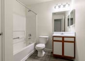 Thumbnail 22 of 22 - A white bathroom with a toilet, sink, and bathtub.