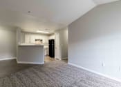 Thumbnail 15 of 22 - A spacious room with a kitchenette and a refrigerator.
