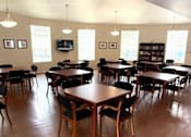 Thumbnail 1 of 22 - Sorrento Villas clubhouse with tables and chairs.