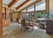 Thumbnail 4 of 46 - a dining room with a table and chairs and a window