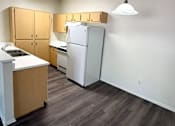 Thumbnail 2 of 22 - Sorrento Villas kitchen with wooden cabinets and a white refrigerator.