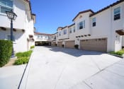 Thumbnail 14 of 35 - Parkside Villas exterior building driveway and garages