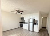 Thumbnail 1 of 15 - A kitchen with white cabinets and a refrigerator.