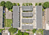 Thumbnail 30 of 32 - A parking lot is surrounded by apartment buildings.