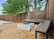 Thumbnail 6 of 32 - A wooden bench sits in front of a wooden fence.