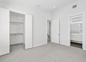 Thumbnail 19 of 32 - A white room with a doorway leading to another room.