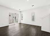 Thumbnail 11 of 32 - A room with wooden floors and white walls.