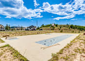 Thumbnail 23 of 30 - A basketball court is being constructed in a grassy area.