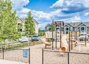 Thumbnail 22 of 30 - A playground with a slide and a fence in the foreground.