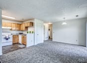 Thumbnail 25 of 30 - A spacious kitchen with wooden cabinets and a white refrigerator.