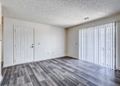 Thumbnail 14 of 30 - A room with a white door and a window with white blinds.