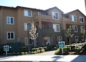 Thumbnail 3 of 6 - an apartment building with a sidewalk in front of it