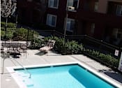 Thumbnail 4 of 6 - a swimming pool in front of an apartment building