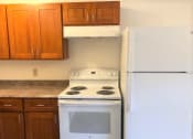 Thumbnail 12 of 20 - The Waterfront Apartments at Kahului kitchen area with gas stove, cabinets, and counters