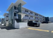 Thumbnail 25 of 27 - a building with a truck parked in front of it