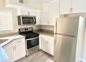 Thumbnail 9 of 15 - 210 Garfield kitchen fridge, stove, and microwave