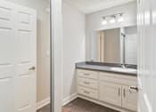 Thumbnail 4 of 6 - a bathroom with a sink and a mirror