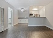 Thumbnail 6 of 6 - an empty living room and kitchen with wood flooring