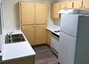 Thumbnail 3 of 22 - Sorrento Villas kitchen with a sink, refrigerator, and cabinets.