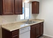 Thumbnail 9 of 19 - Hampton Court Apartments kitchen cabinets, sink, and dish washer