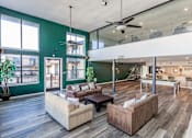 Thumbnail 19 of 41 - A living room with a green wall and a ceiling fan.