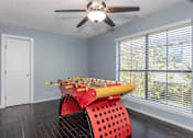 Thumbnail 21 of 41 - A room with a red chair and a yellow xylophone.