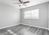 Thumbnail 39 of 41 - A room with a ceiling fan and a window with blinds.