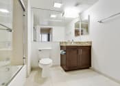 Thumbnail 13 of 23 - a bathroom with a toilet and a sink and a shower
