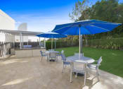 Thumbnail 21 of 23 - a patio with tables and chairs and umbrellas