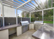 Thumbnail 7 of 23 - the outdoor kitchen has stainless steel appliances and stainless steel counters